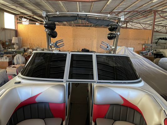 Finished boat windshield tint — dark film on wakeboard boat