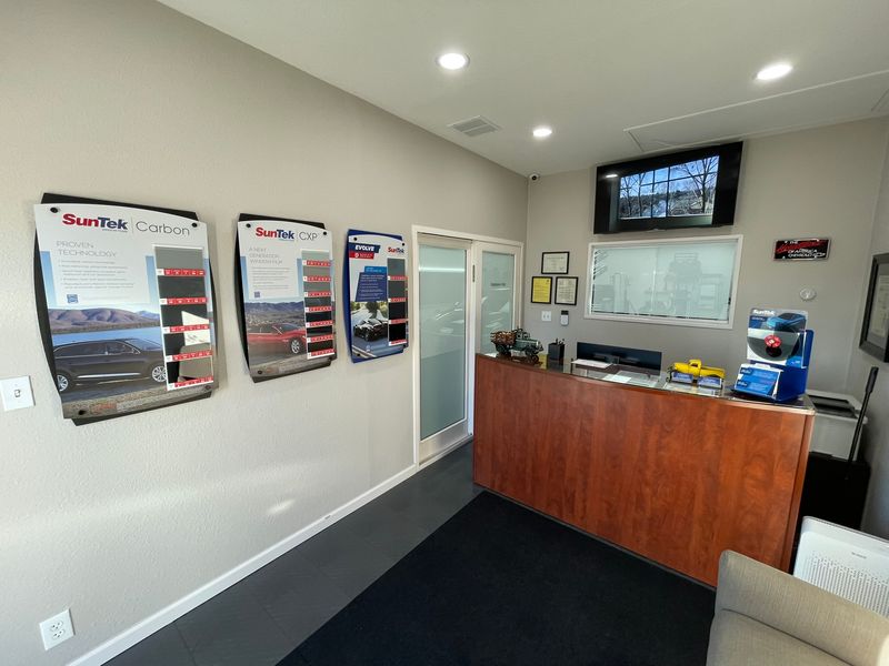 Pacific Window Tint front desk with SunTek Carbon and CXP film samples