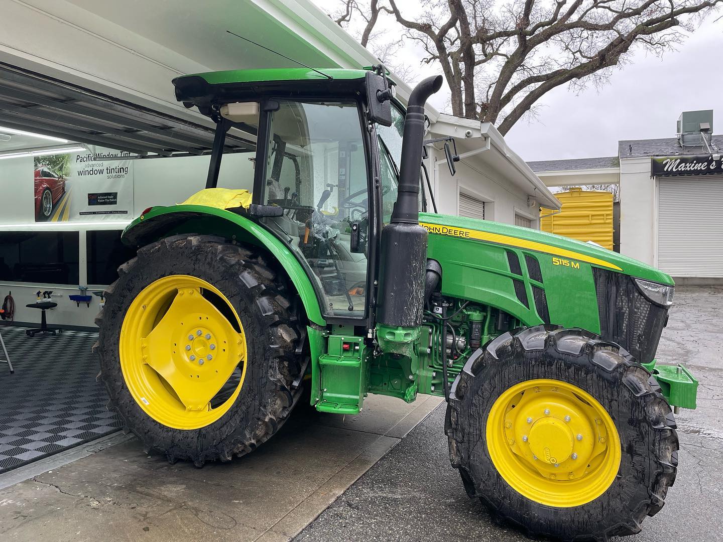 Green John Deere tractor with freshly tinted cab windows